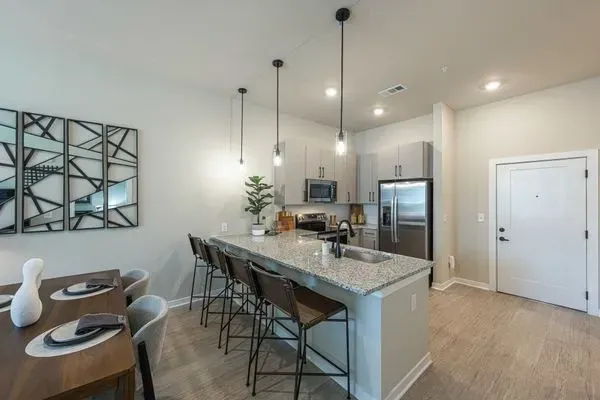 A kitchen with granite counter tops and stainless steel appliances