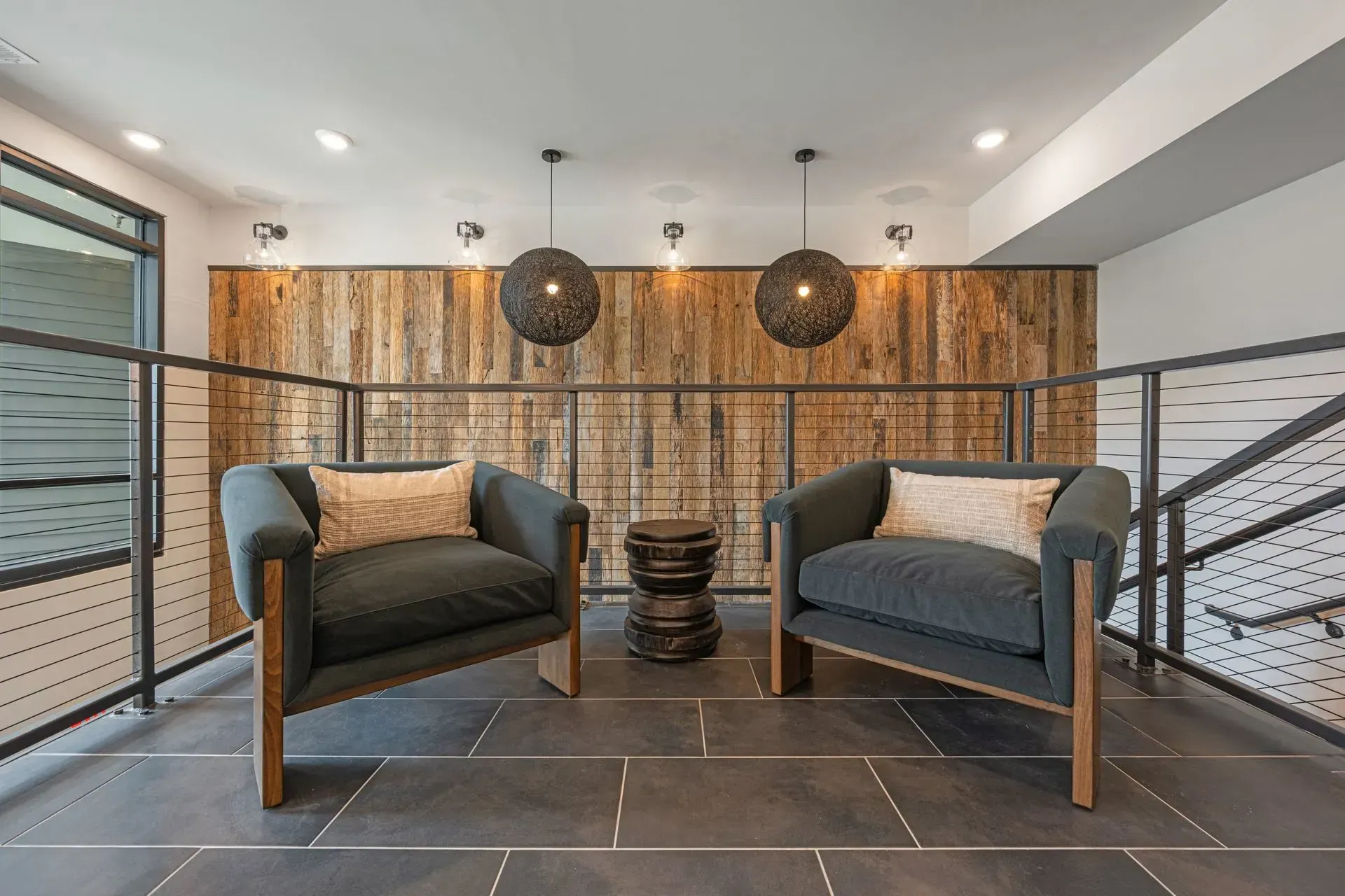 Two chairs and a table in a room with a wooden wall