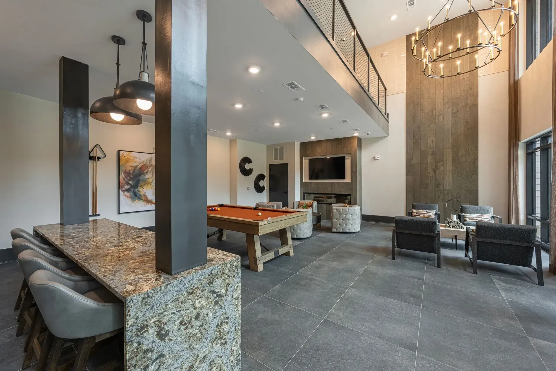 A large room with a pool table and chairs