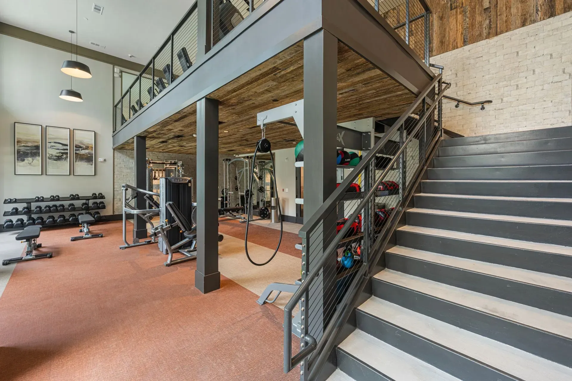 A gym with stairs leading up to the second floor