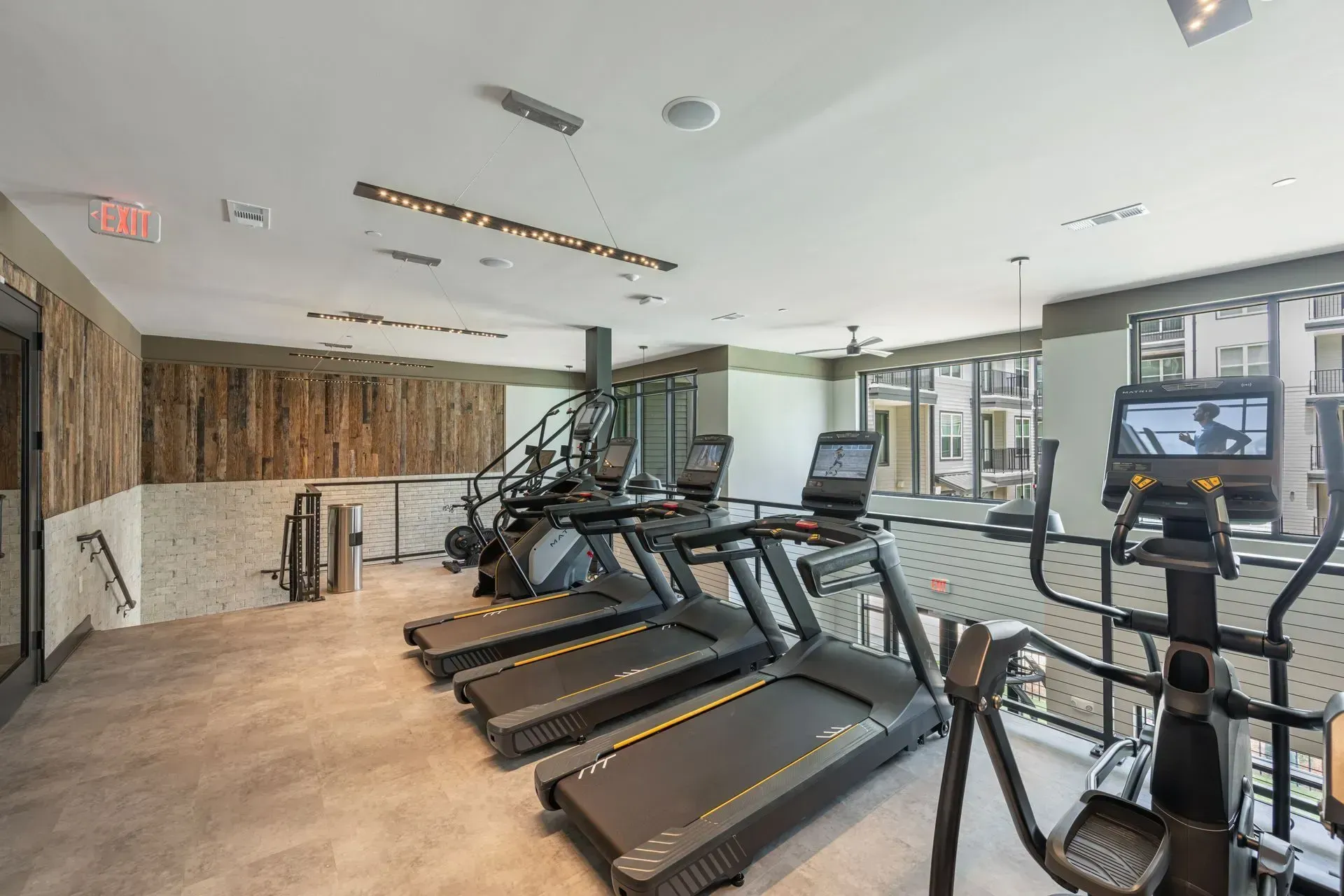 A gym with a lot of treadmills and ellipticals