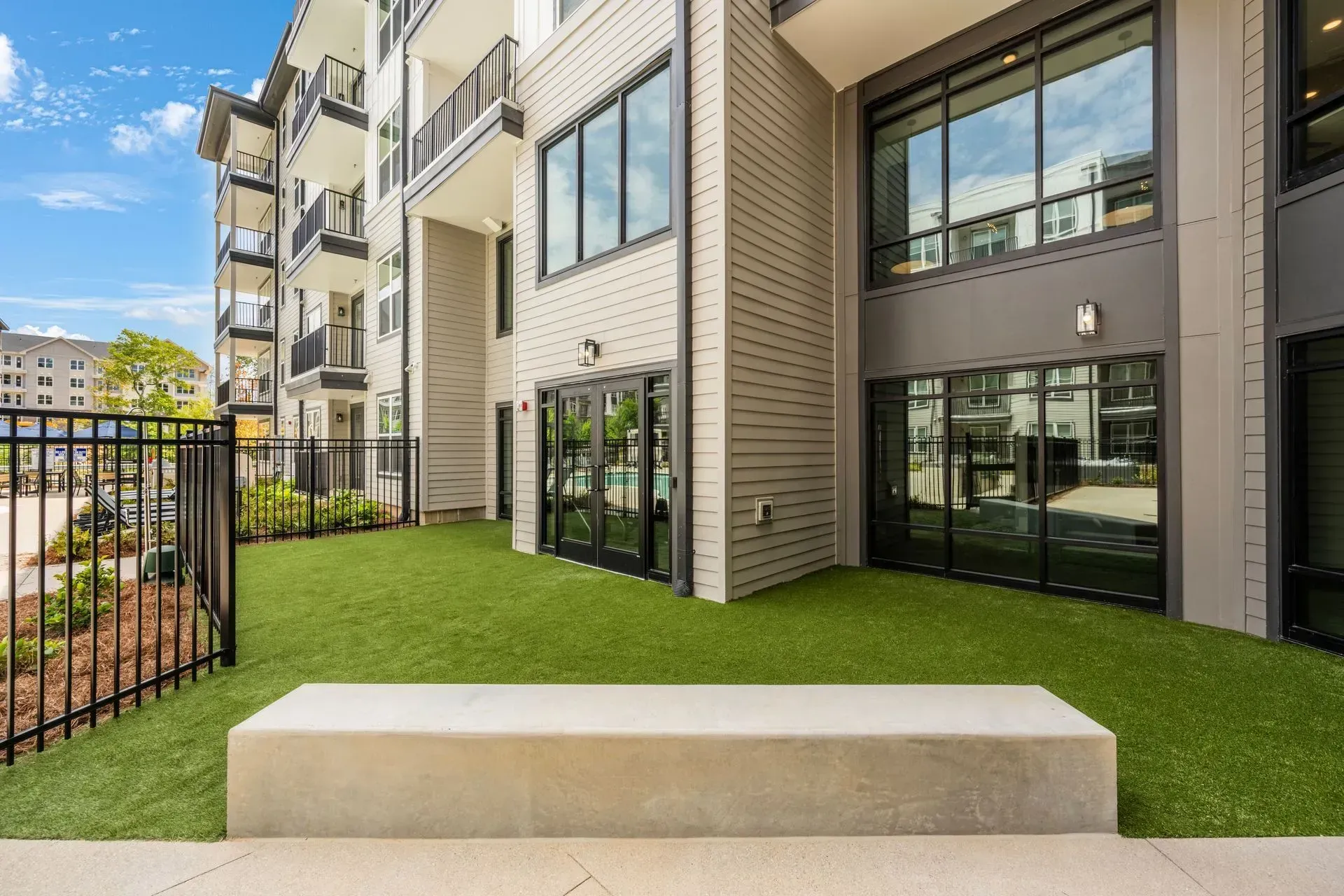 A building with a lot of windows and a bench in front of it