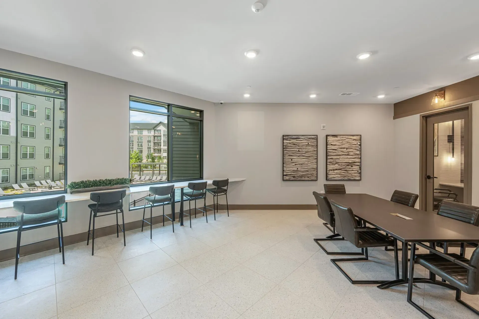 A large room with a long table and chairs