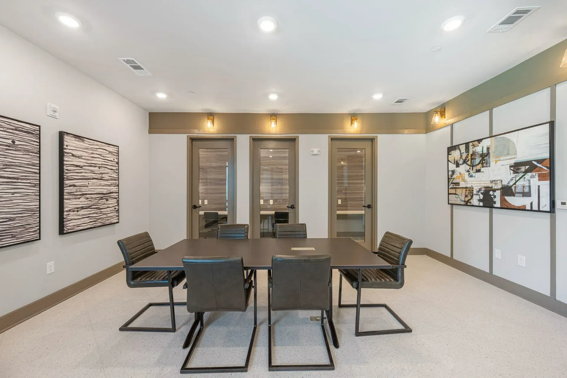 A conference room with a table and chairs in it