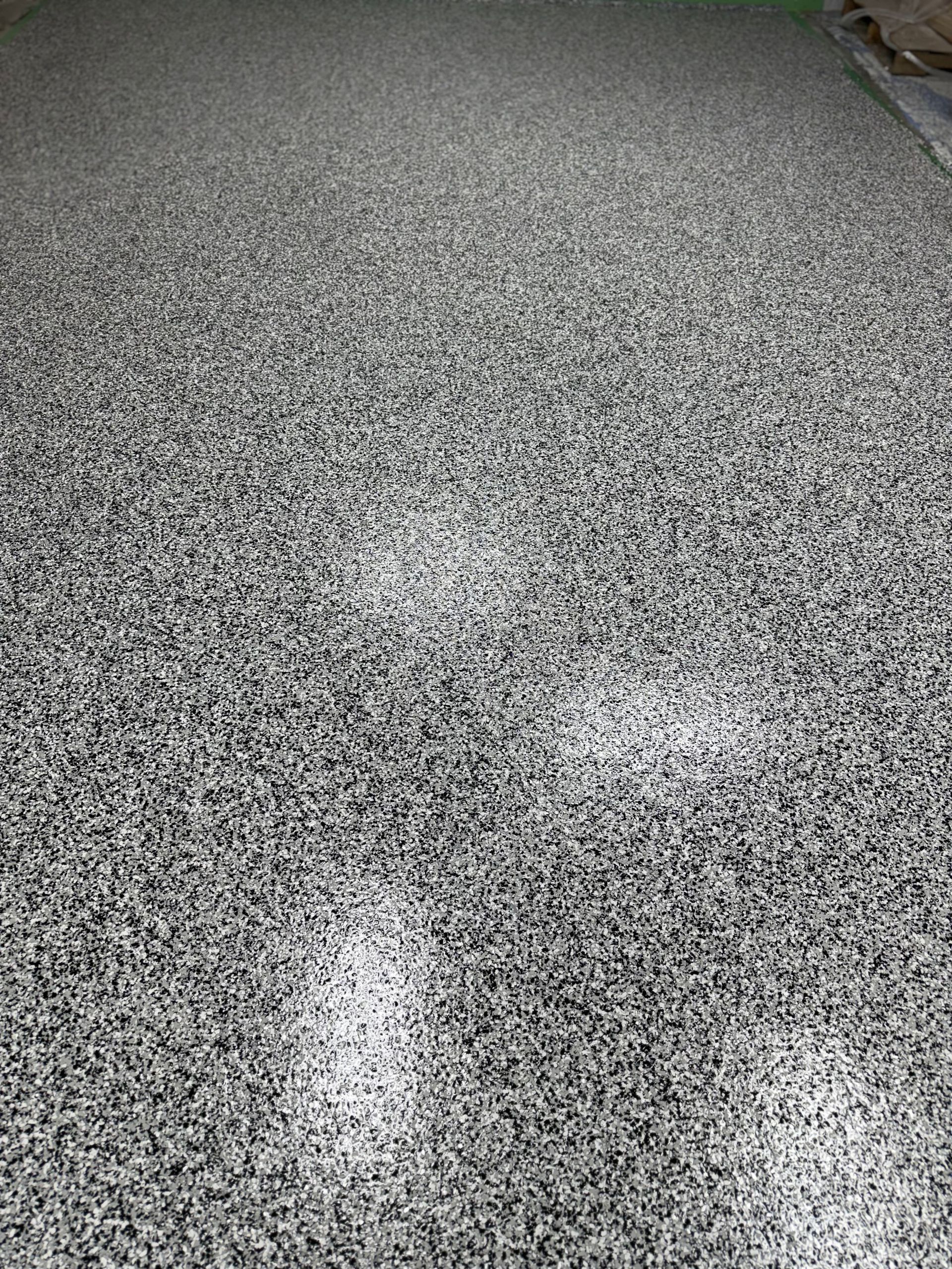 Gray concrete surface with scratches and textured patches.