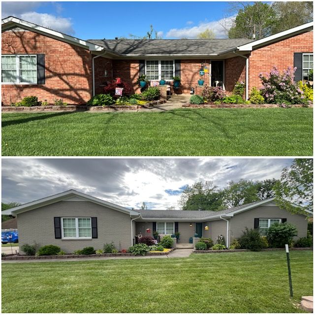 Red and black garage with two doors, a side door, and a chimney.