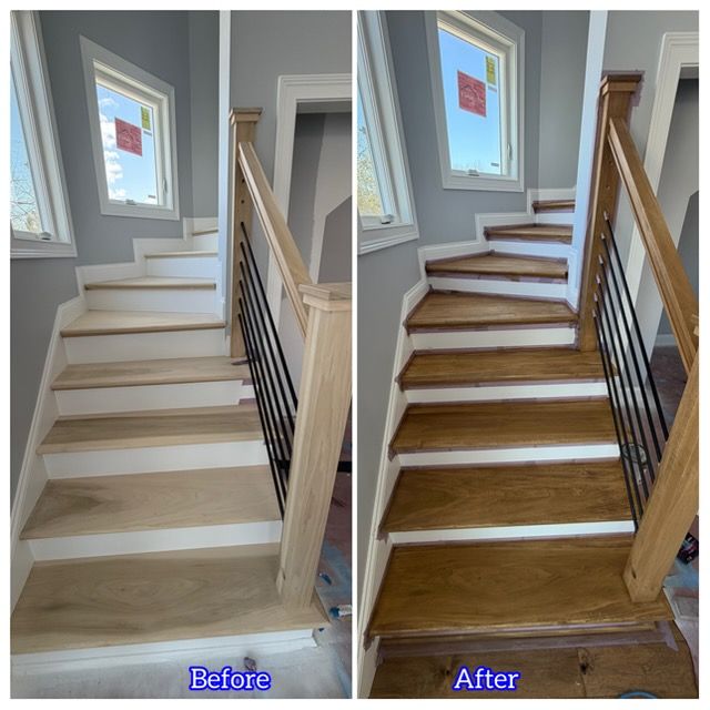 Empty living room with tile floor, paneled walls, dark beams, and a brick fireplace.