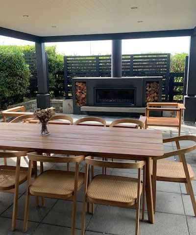 Patio With Chairs, Table, And Fireplace — Auckland, NZ — Serenity Landscapes