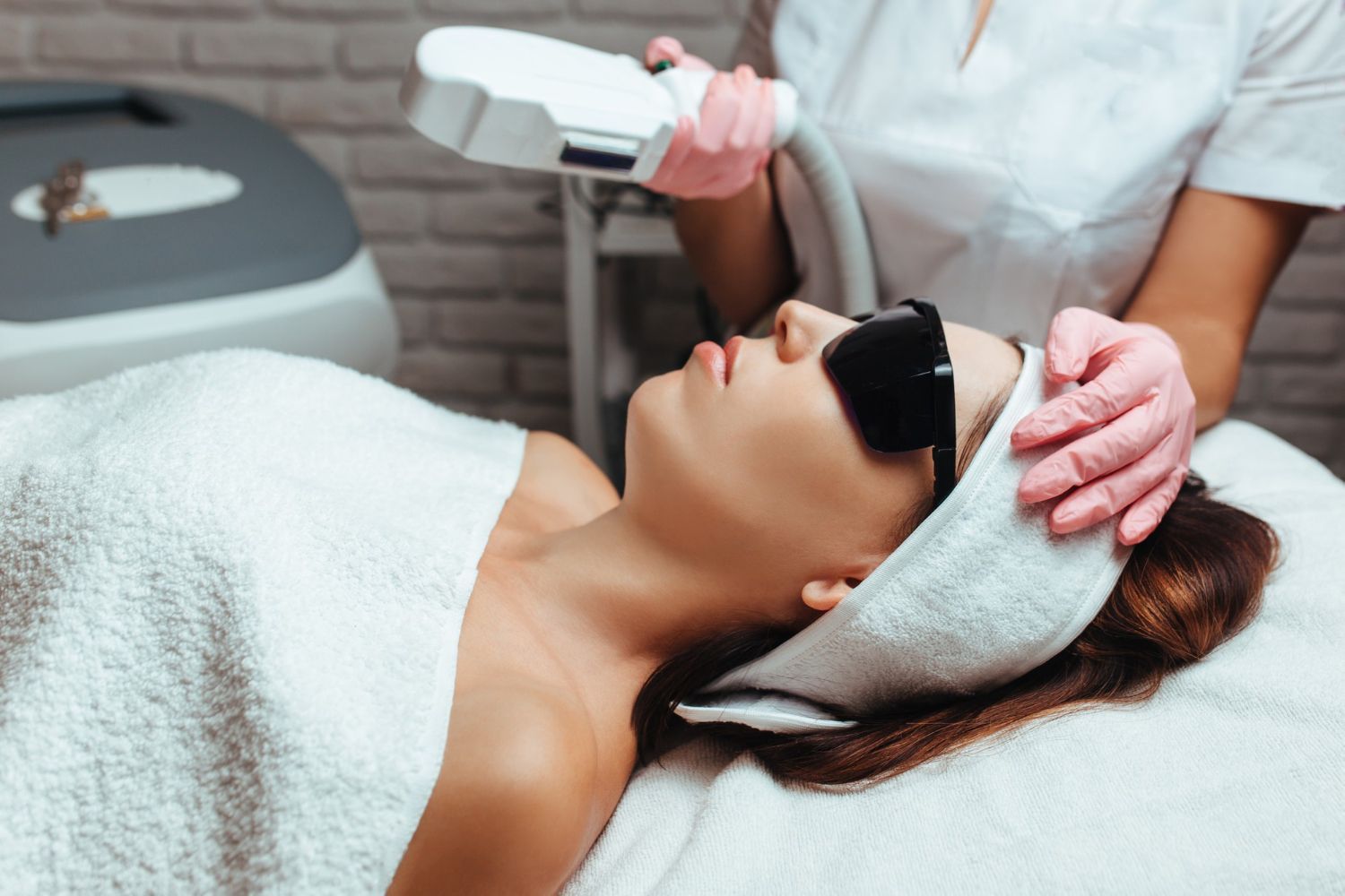 Une femme subit un traitement d'épilation au laser sur son visage.