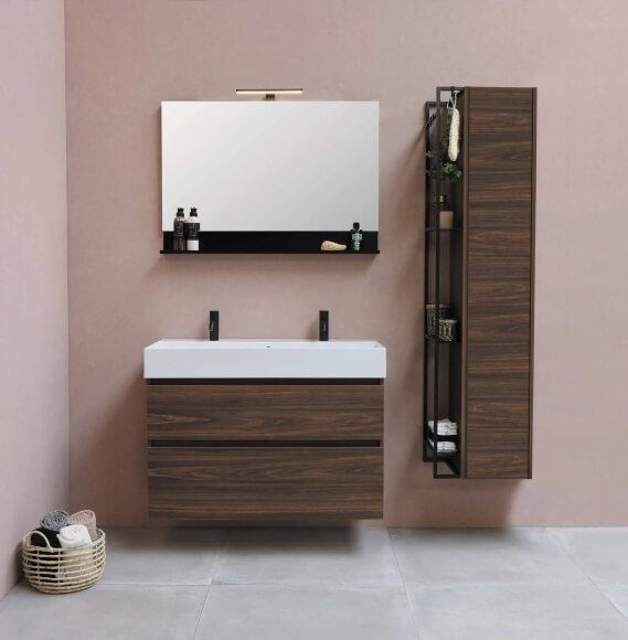 washroom with pink walls and frameless mirror