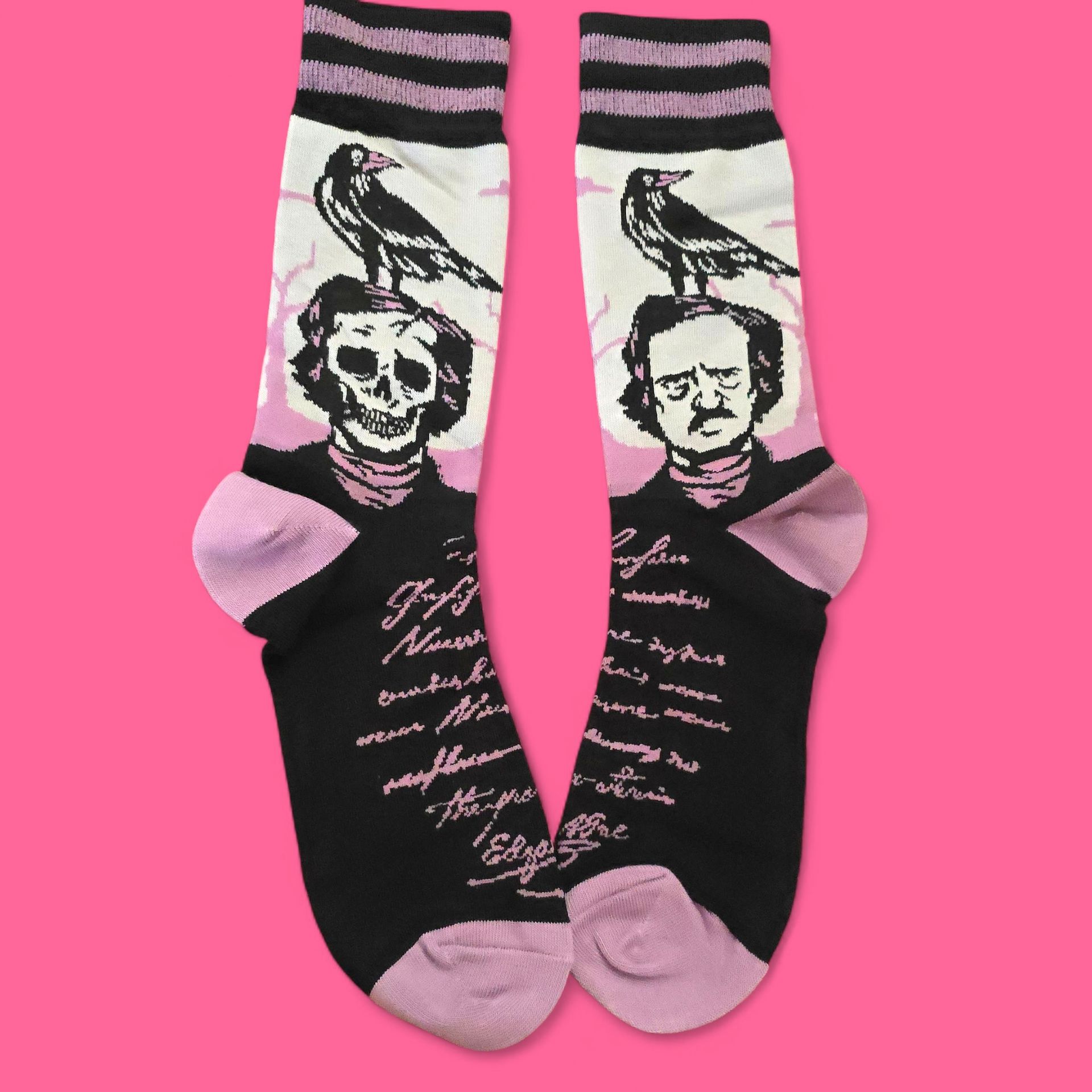 Par de calcetines negros con ilustración de Edgar Allan Poe. Presentan un cuervo y fragmentos de un poema en blanco y rosa.