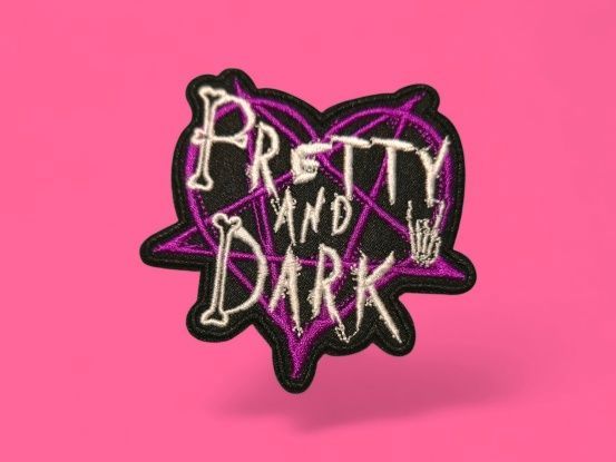 Parche bordado con el texto "Pretty and Dark" dentro de una forma de corazón