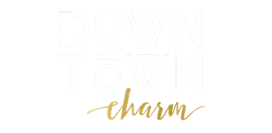 “Down Town” logo with gold cursive “charm” on a white background