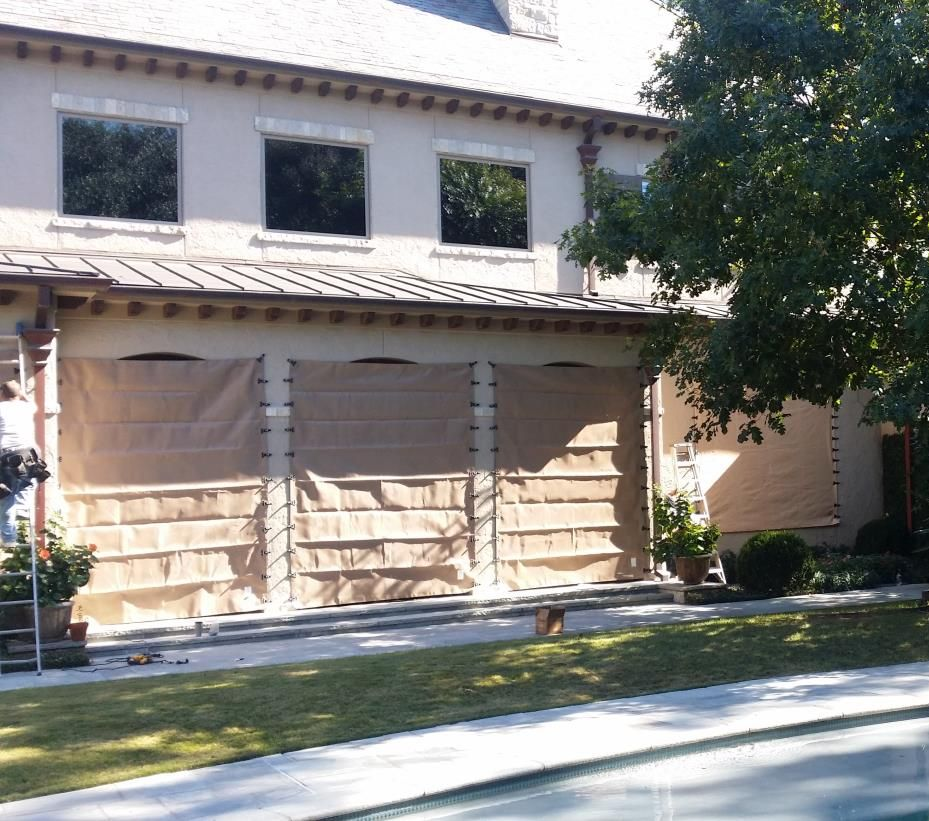 A window with wooden shutters on a brick wall