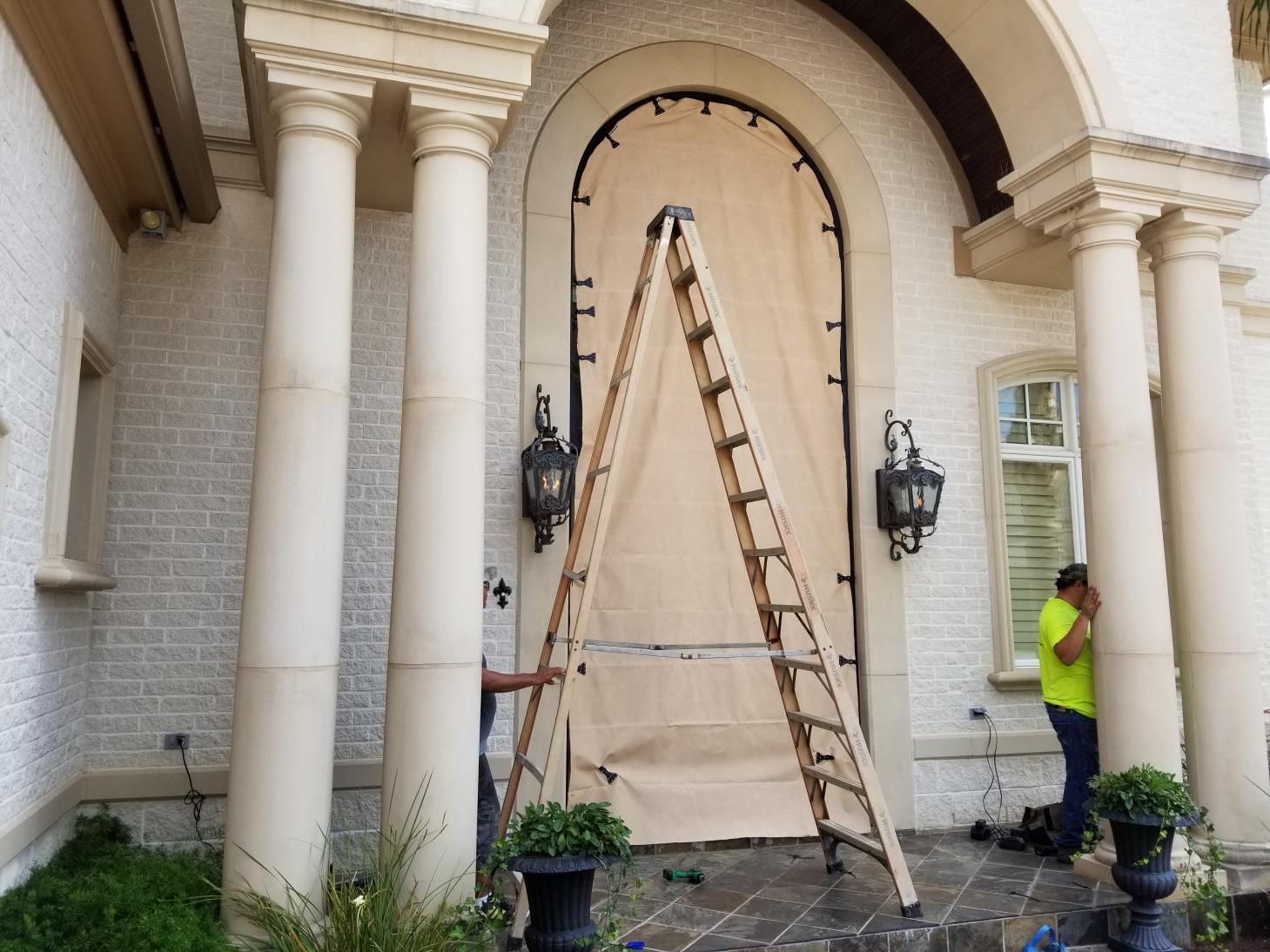 A window with wooden shutters on a brick wall