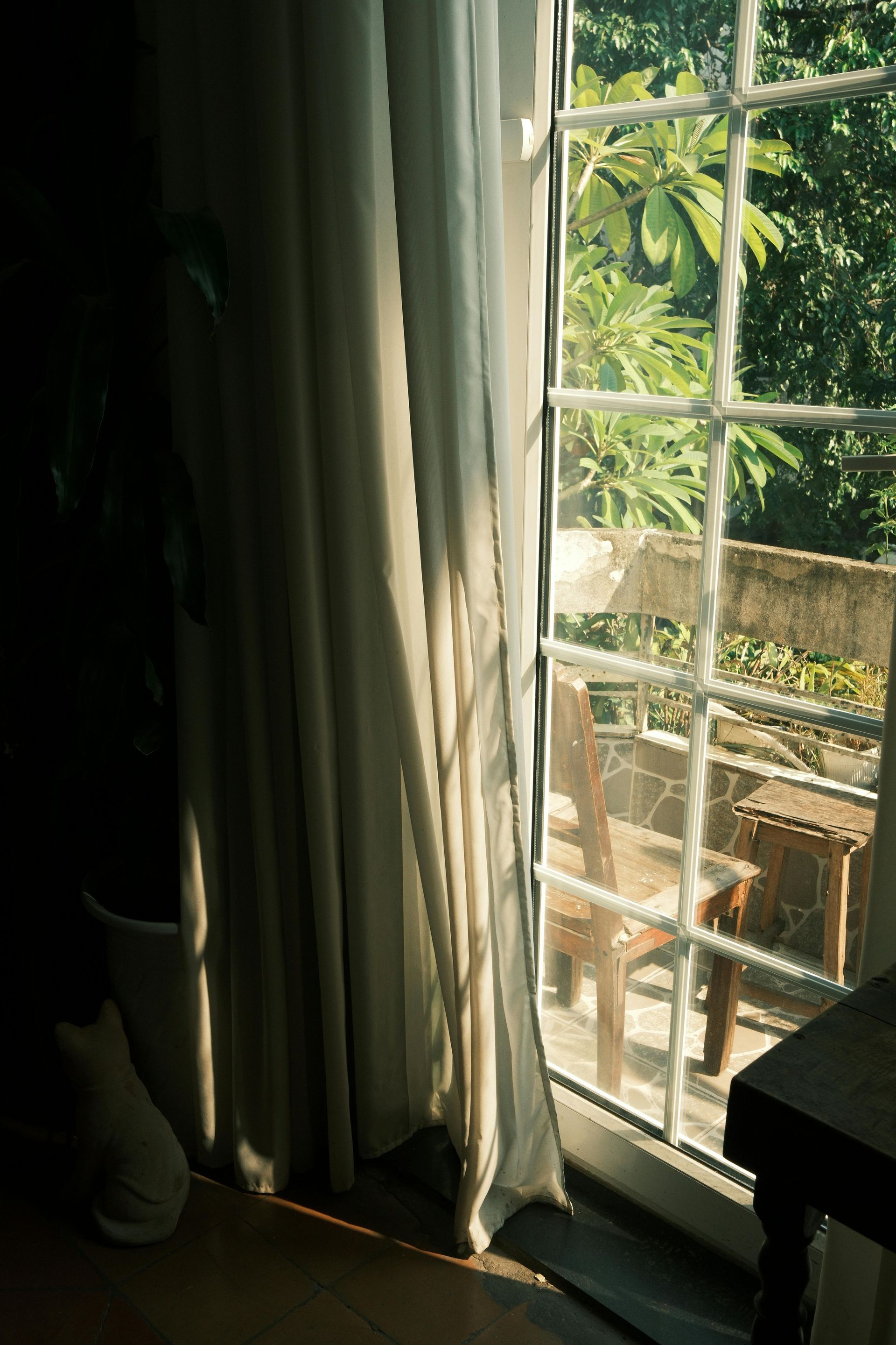 A window with wooden shutters on a brick wall