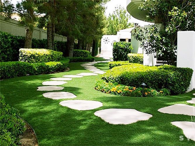 A lush green garden with a path going through it