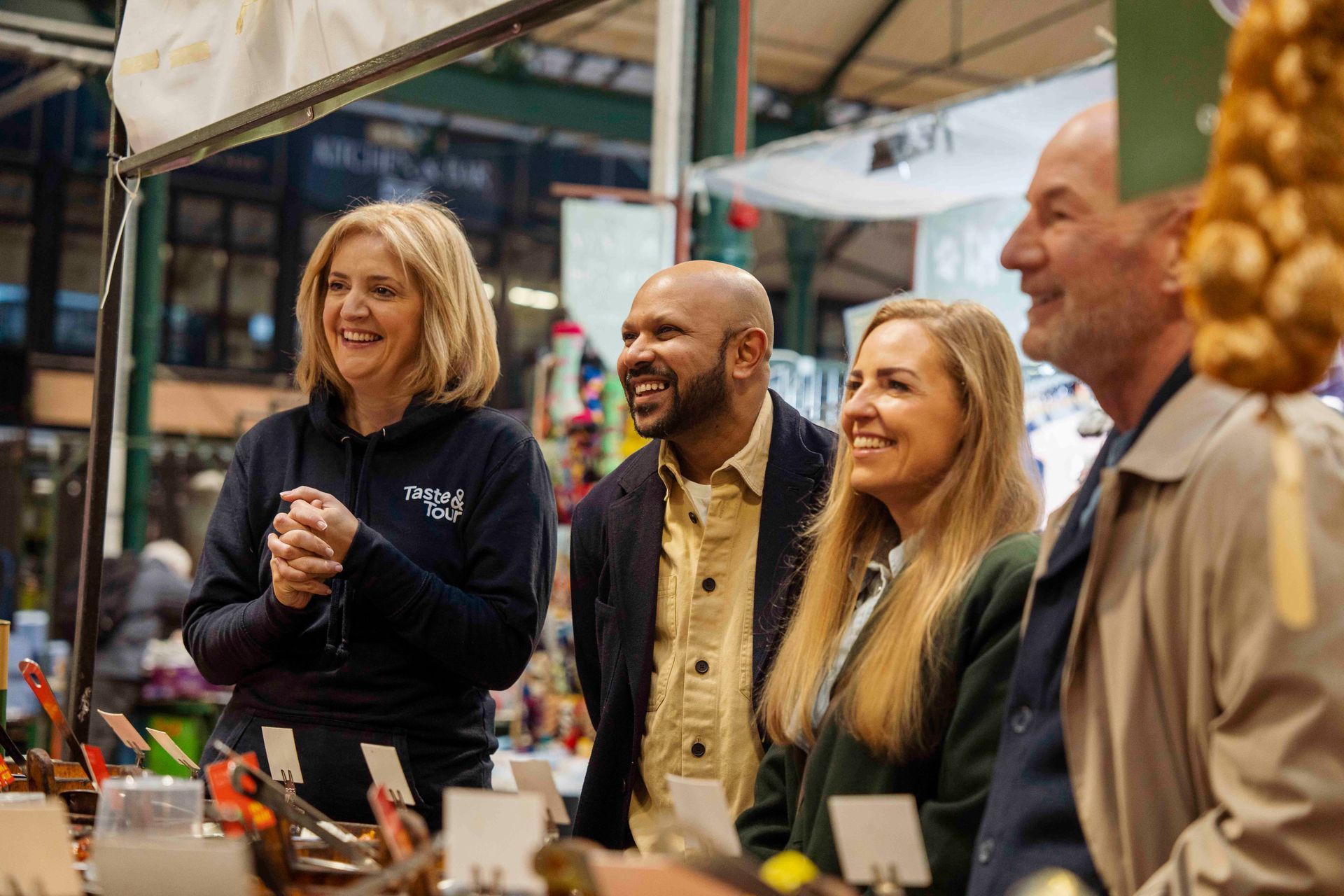 A man with a backpack is standing on top of a grassy hill.
