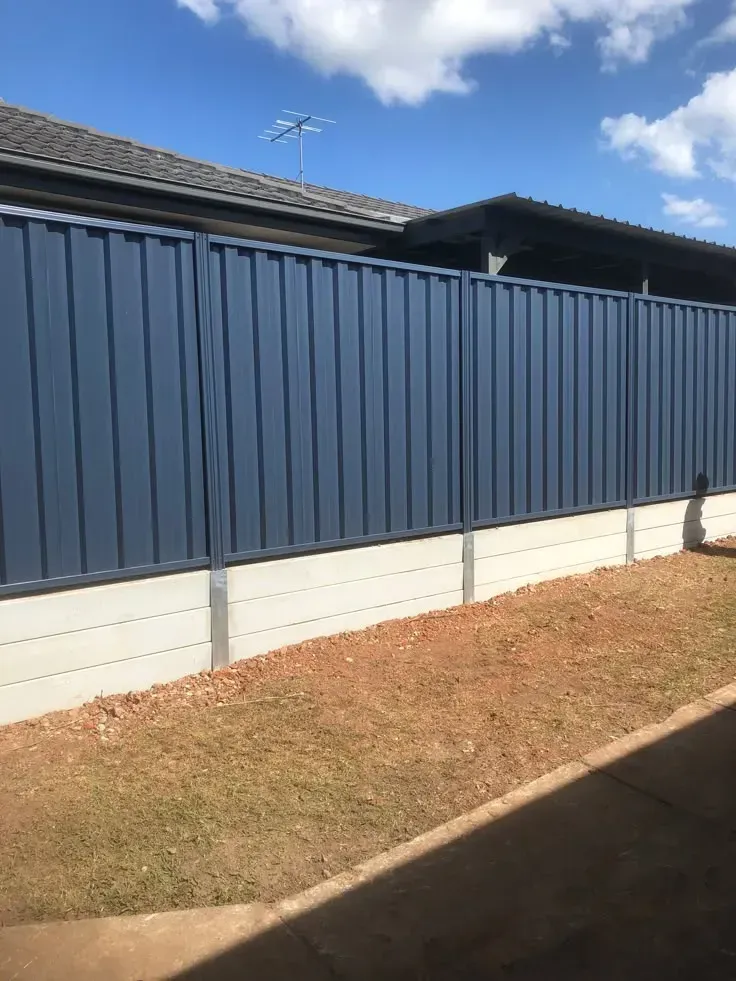 A close-up of a tan colour bond fence .