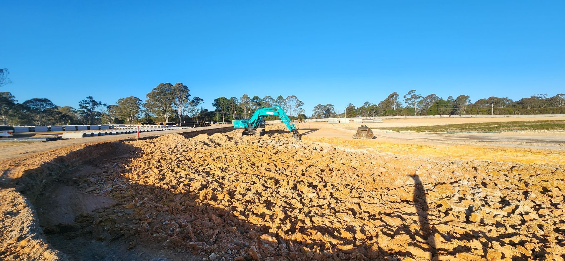 A Dump Truck Parked in a Dirt Field With its Bed Raised for Unloading — Earthmoving in Maitland, NSW