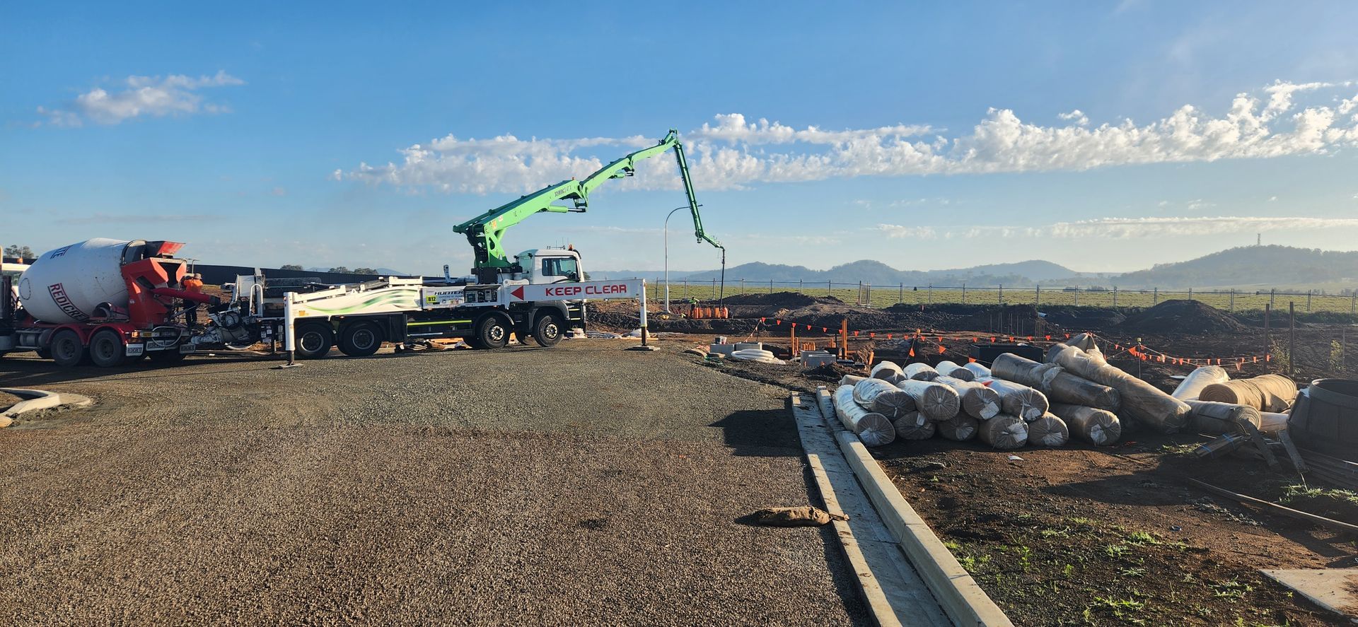 Construction Site With Concrete Mixer Truck and Pump Arm — Earthmoving in Maitland, NSW