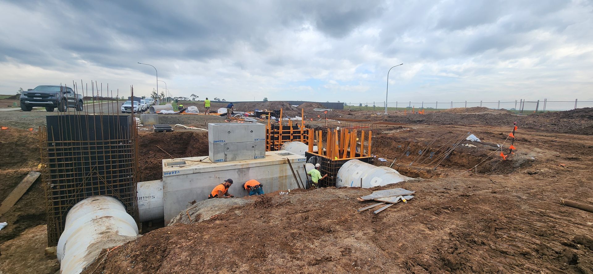 Construction Site With Workers, Concrete Structures, Pipes, and Earthworks — Earthmoving in Maitland, NSW