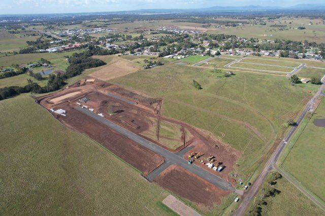 Aerial View of a Construction Site a Partially Built Road Cuts Through a Green Field Near a Small Town — Earthmoving in Maitland, NSW