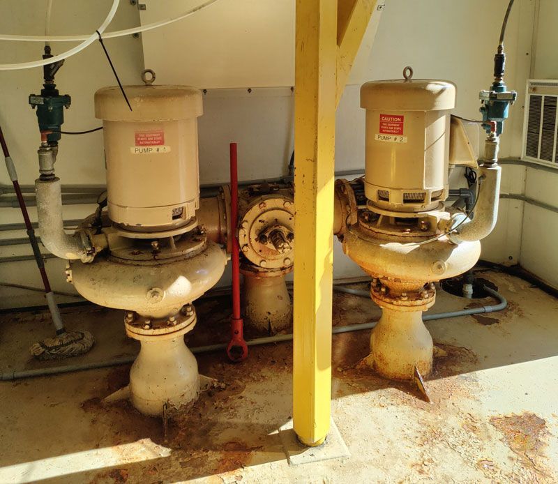Two pumps are sitting next to each other in a room