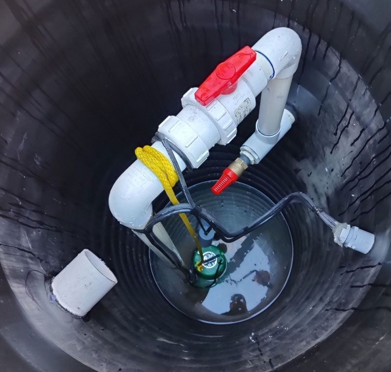 A building with a roof that has a few trees in the background