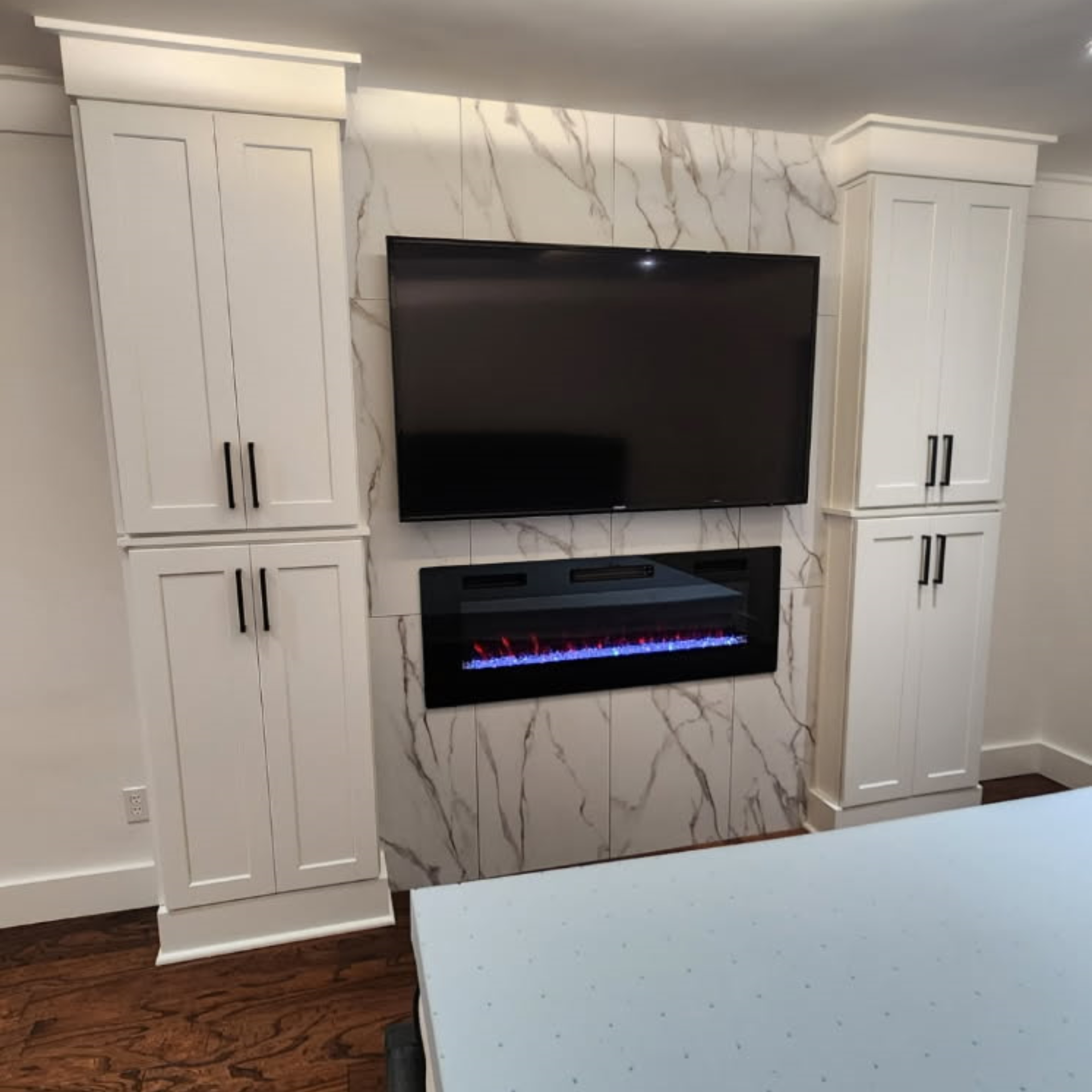 Bathroom with dual sinks, shower, and dark granite countertops.