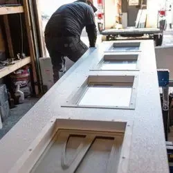 Garage door technician assembling a new garage door. Professional installation and repair services for homes and businesses.