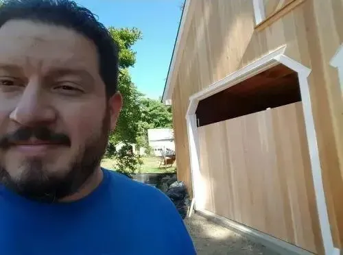 Wooden garage door installation in progress. Expert residential garage door replacement and repair services available.