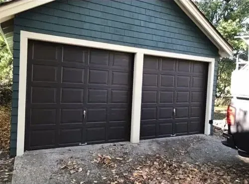 New garage door installation with dark brown panels. Expert residential garage door service for secure and stylish upgrades.
