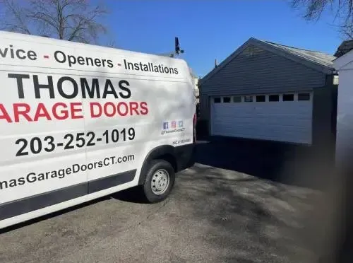 Thomas Garage Doors service van at a job site. Providing expert garage door installation, repair, and replacement services.
