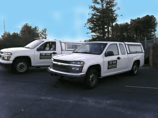 White bathtub with dark bronze faucet and tiled walls, black grout.