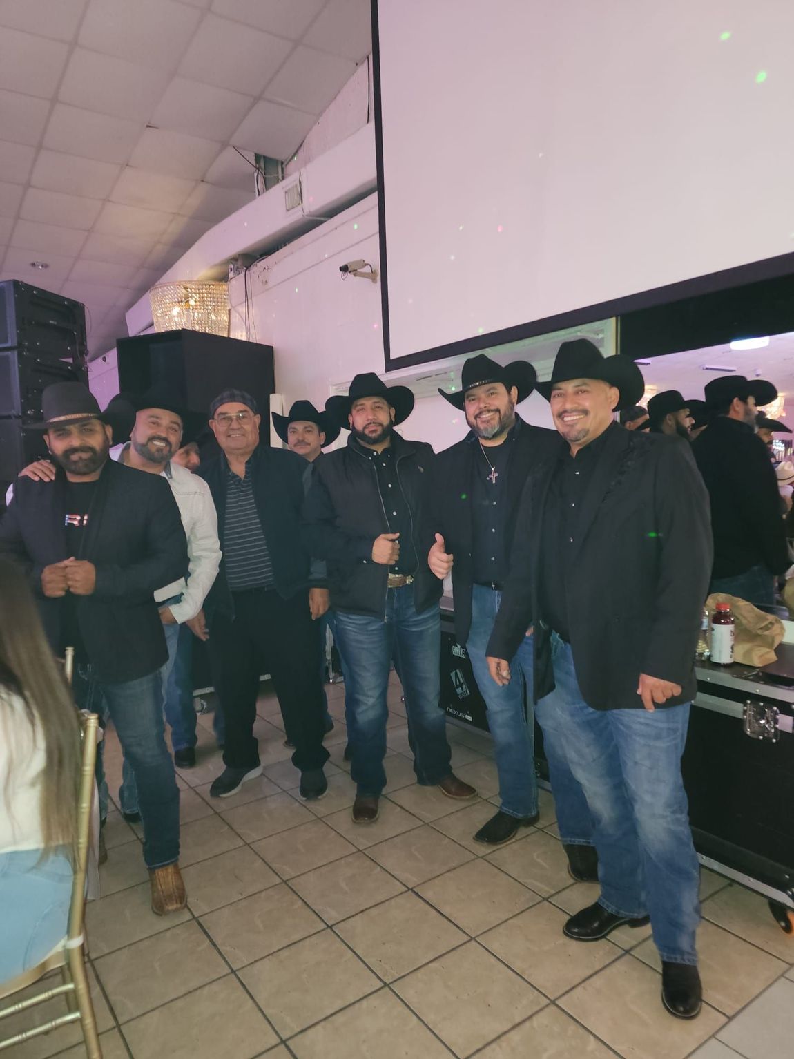 Grupo Orgullo wearing cowboy hats are posing for a picture