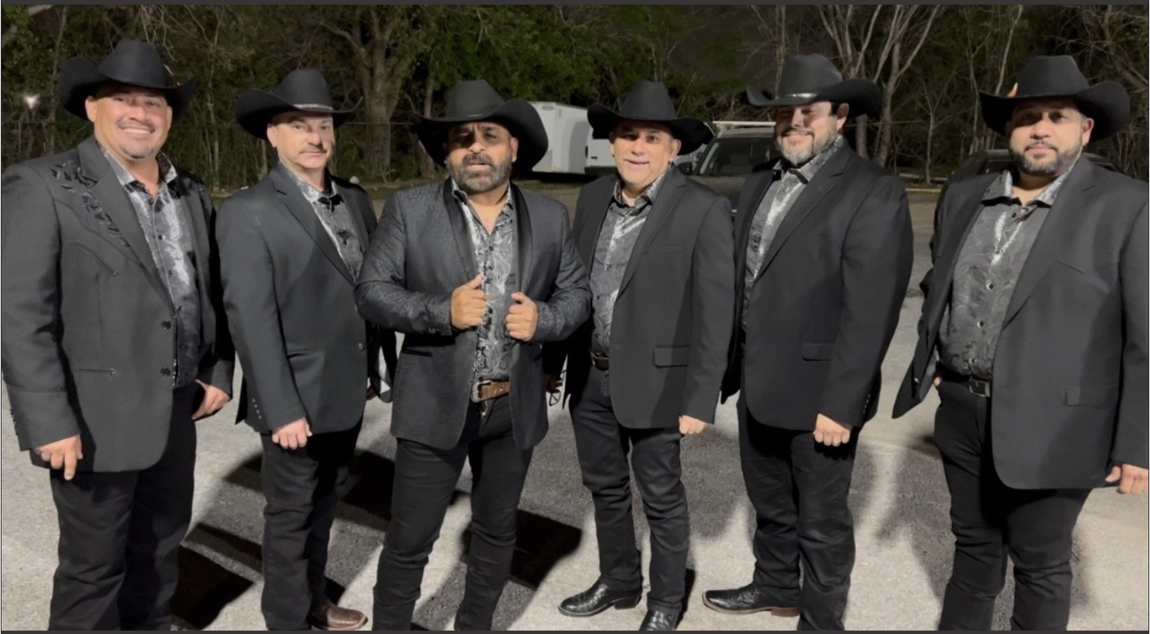 Grupo Orgullo in suits and cowboy hats are posing for a picture.