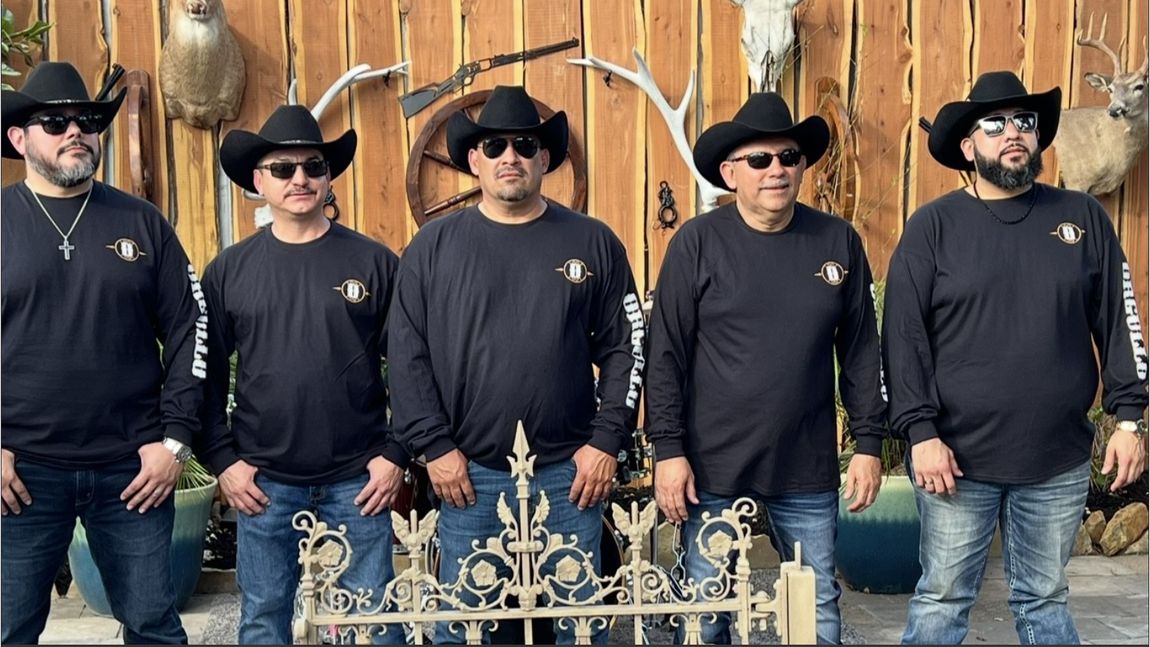 Grupo Orgullo wearing cowboy hats and sunglasses are posing for a picture.