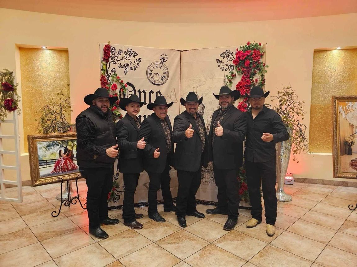 Grupo Orgullo in cowboy hats are posing for a picture.