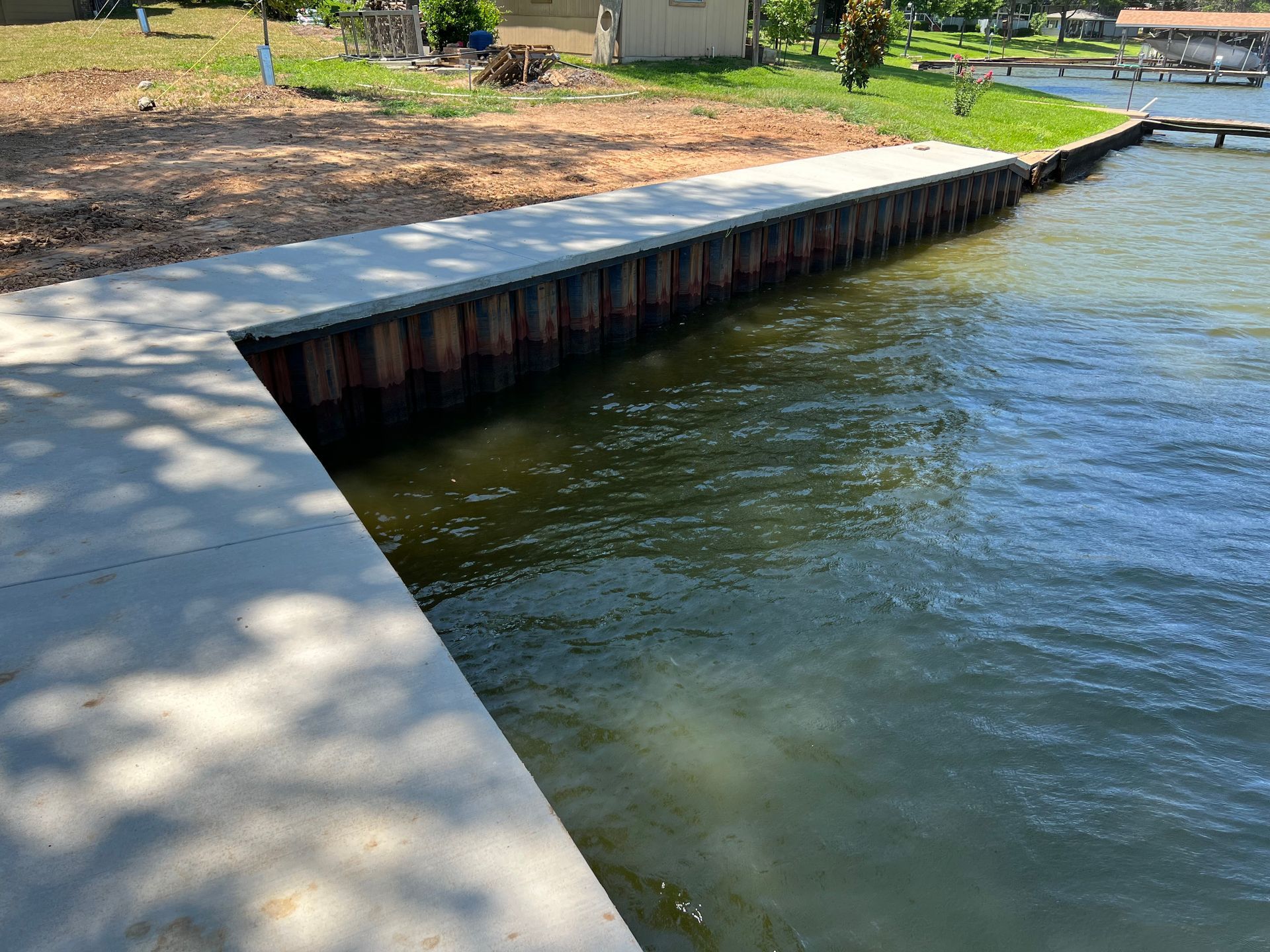 A dock is being built next to a body of water.