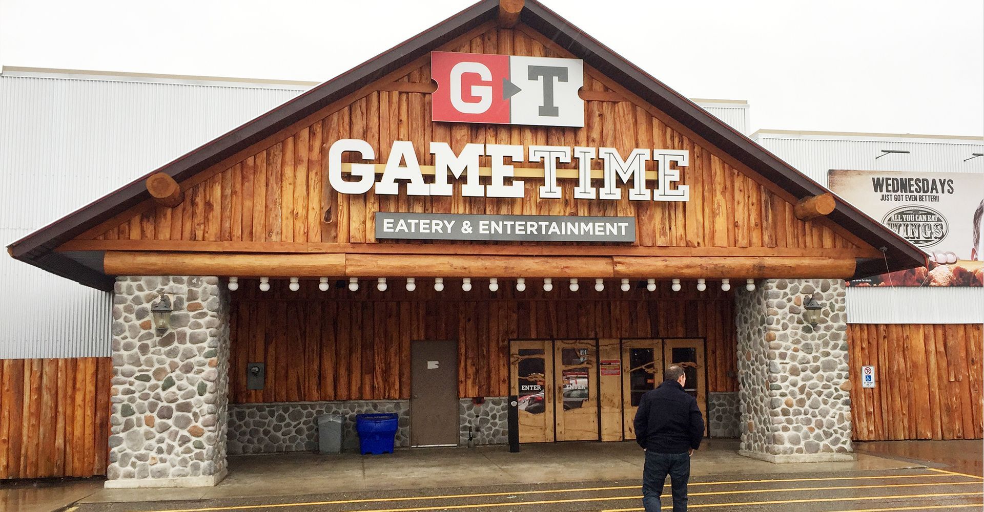 A man standing in front of a gametime store