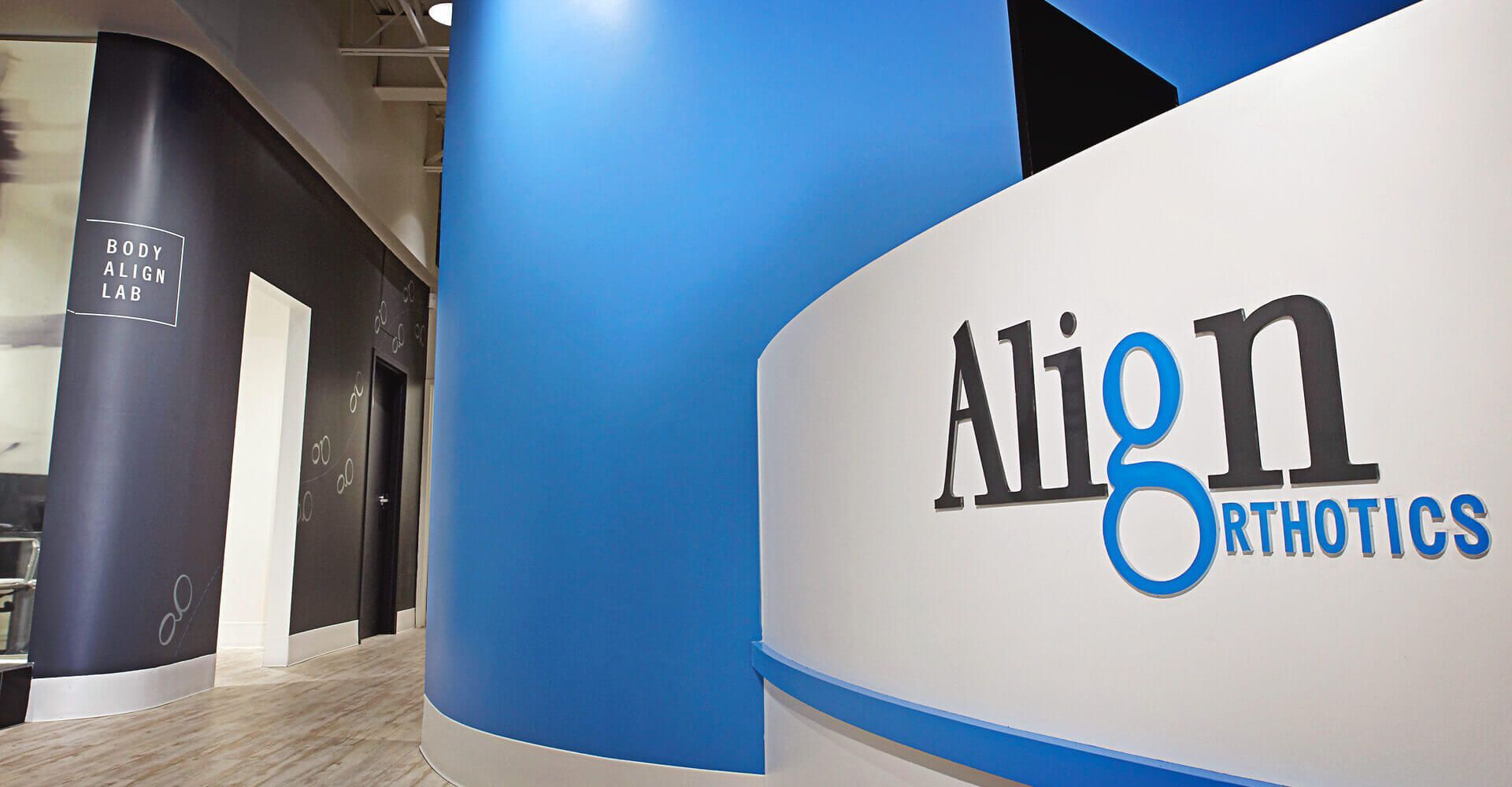 A blue and white sign that says align orthotics