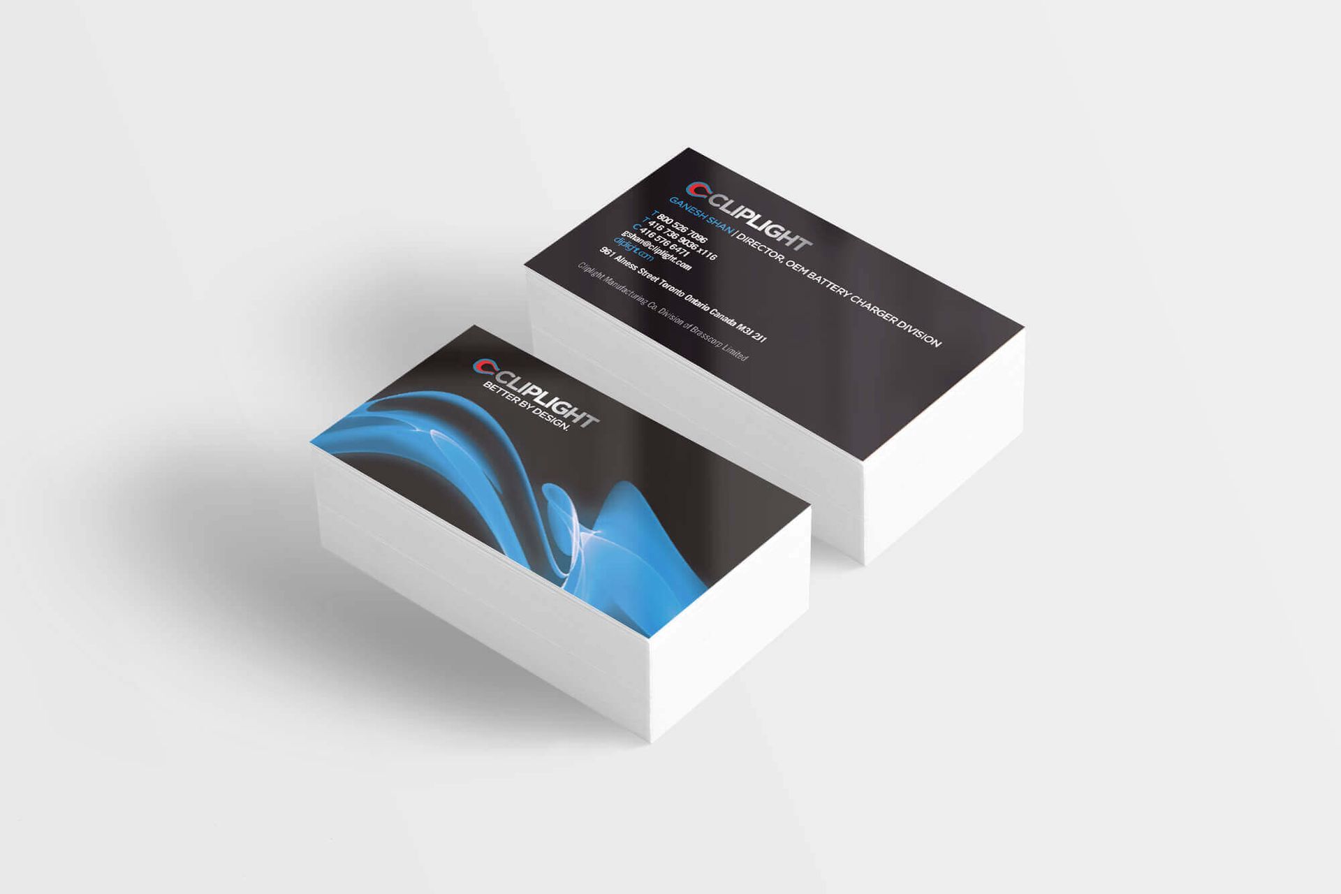 Two business cards are stacked on top of each other on a white surface.