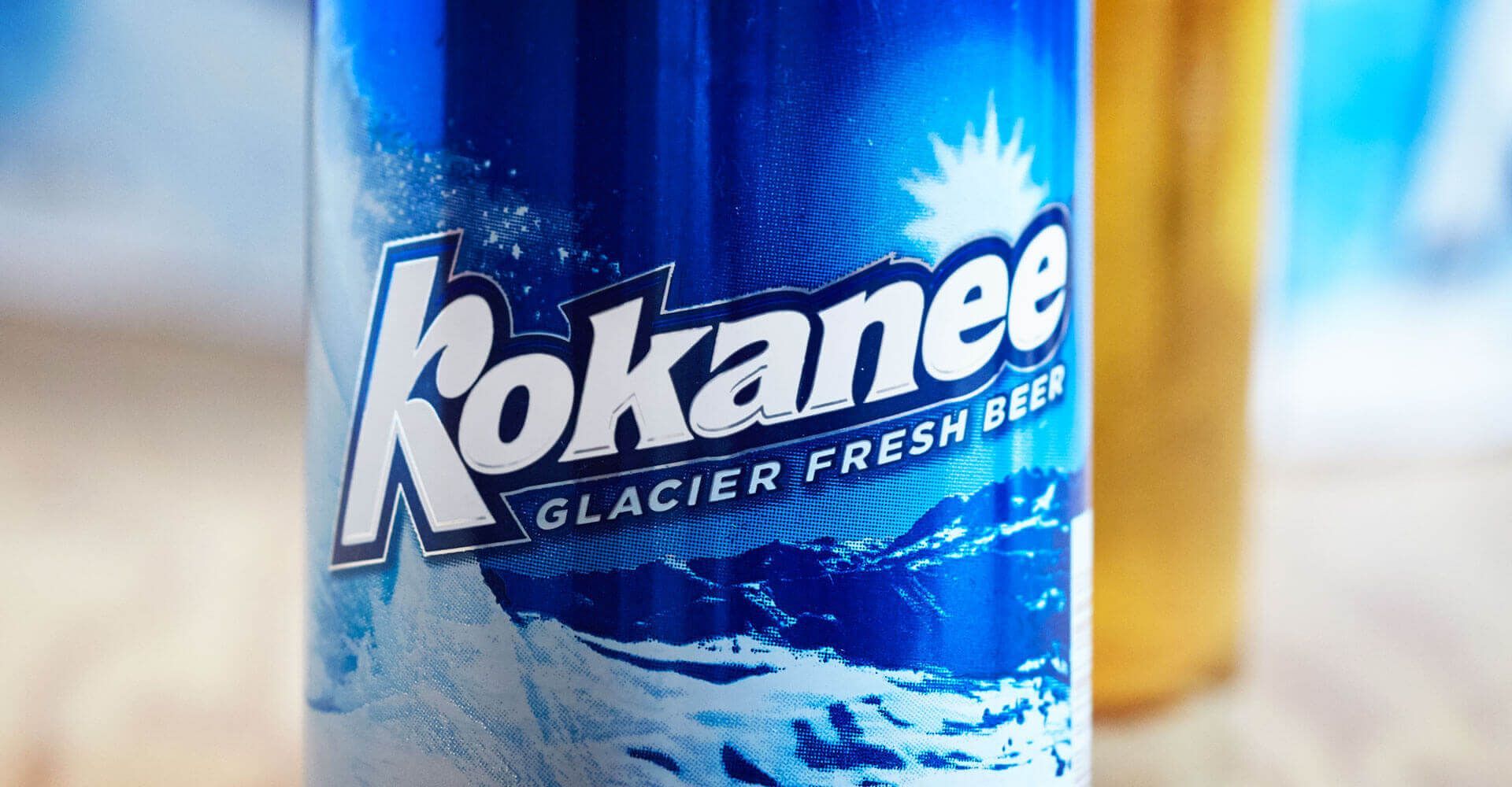 A bottle of kokanee beer is sitting in the snow