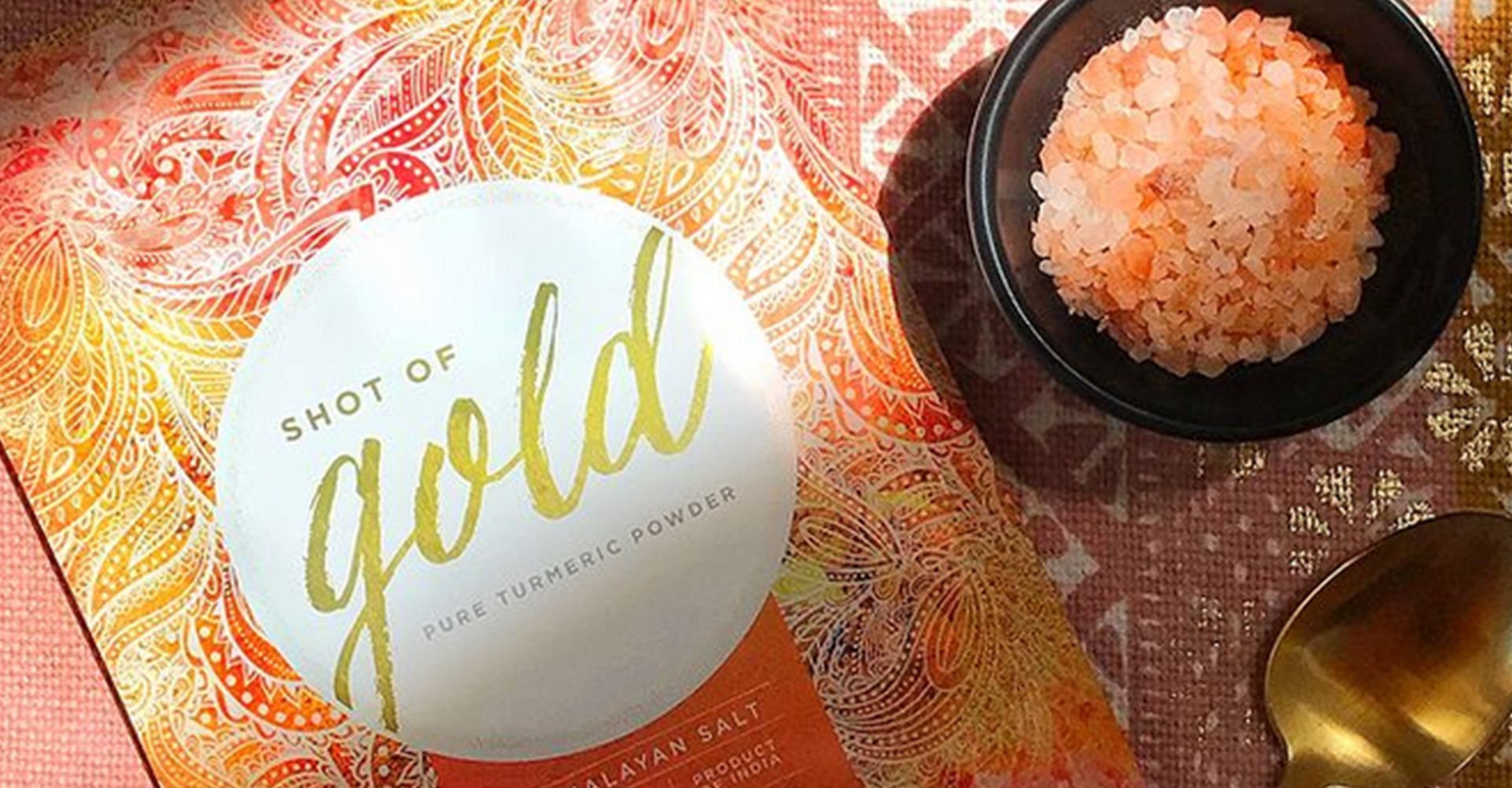A book called shot of gold is sitting on a table next to a bowl of salt.
