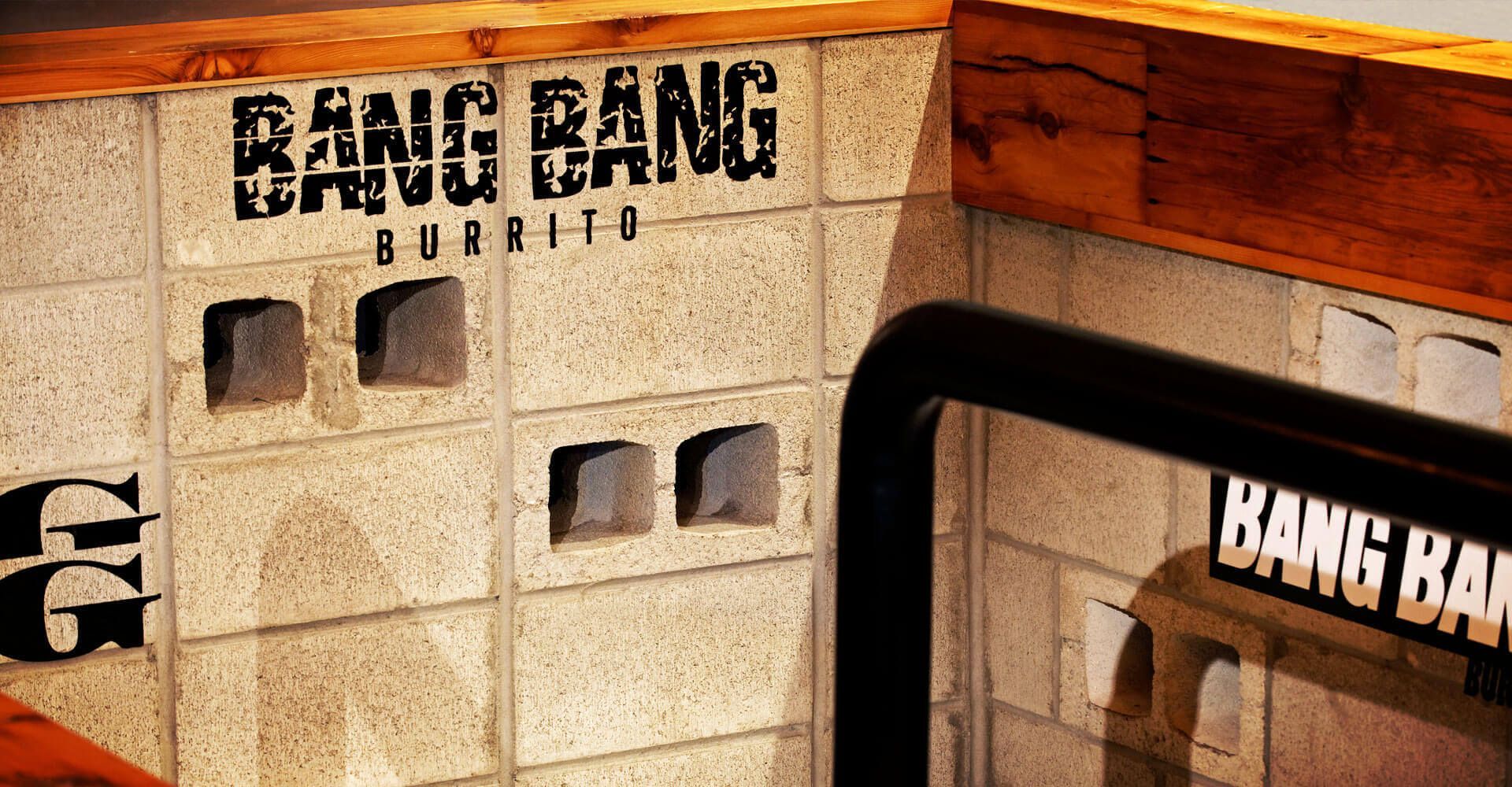 A brick wall with the words bang bang burrito written on it