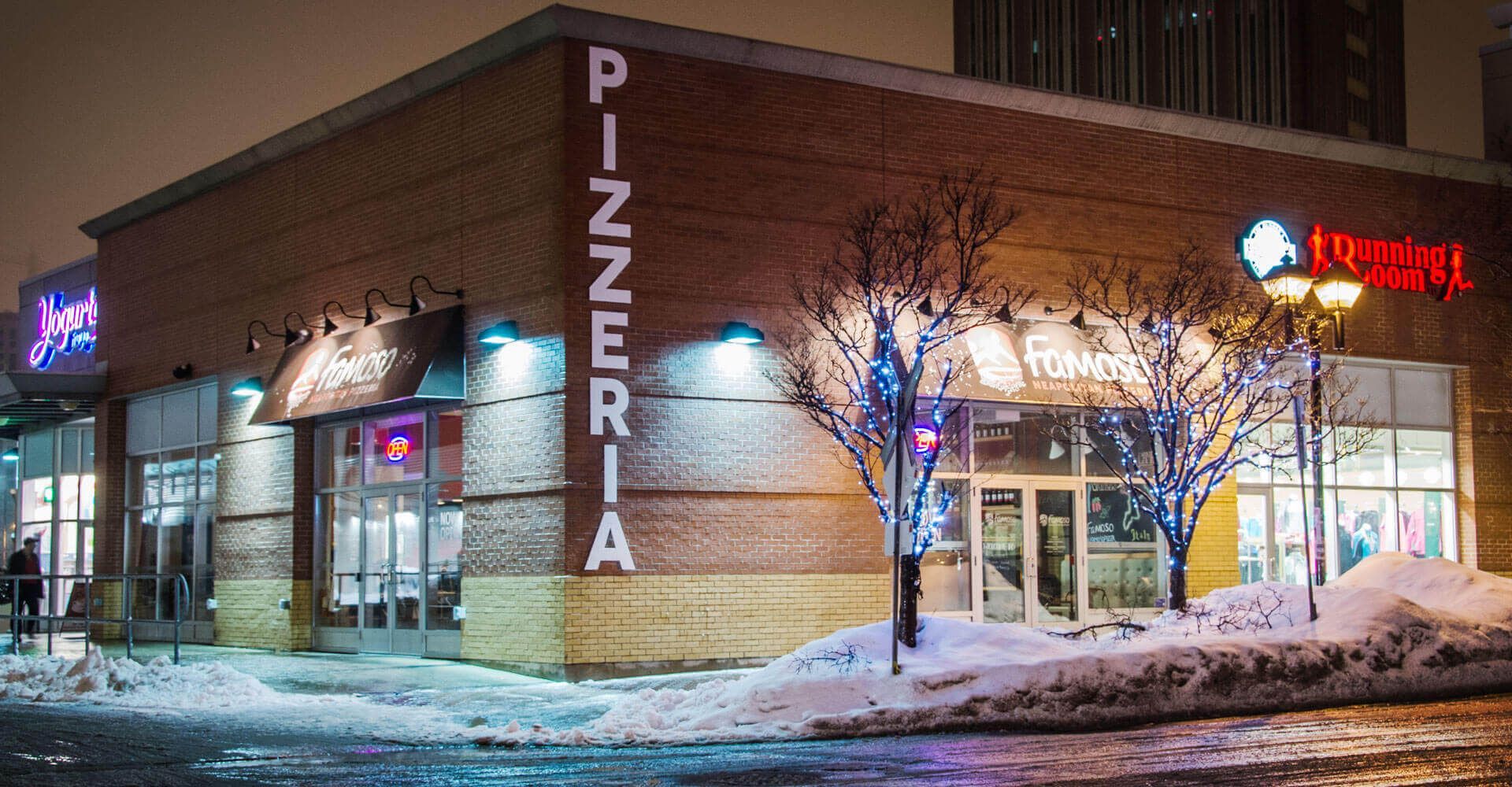 A brick building with a sign that says pizzeria on it.