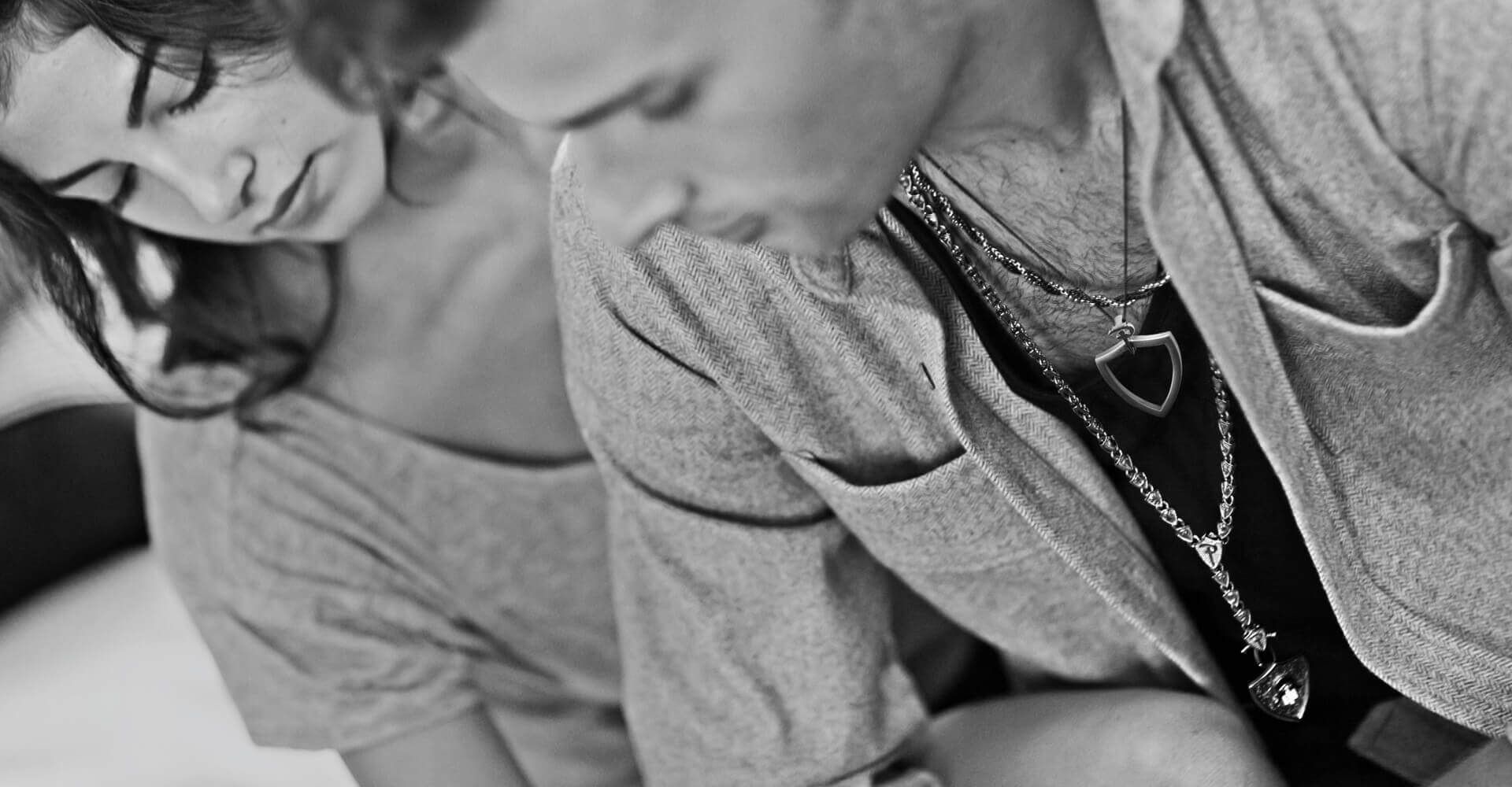 A black and white photo of a man and a woman sitting next to each other.