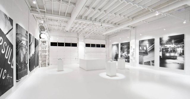 A large white room with a lot of pictures on the wall.