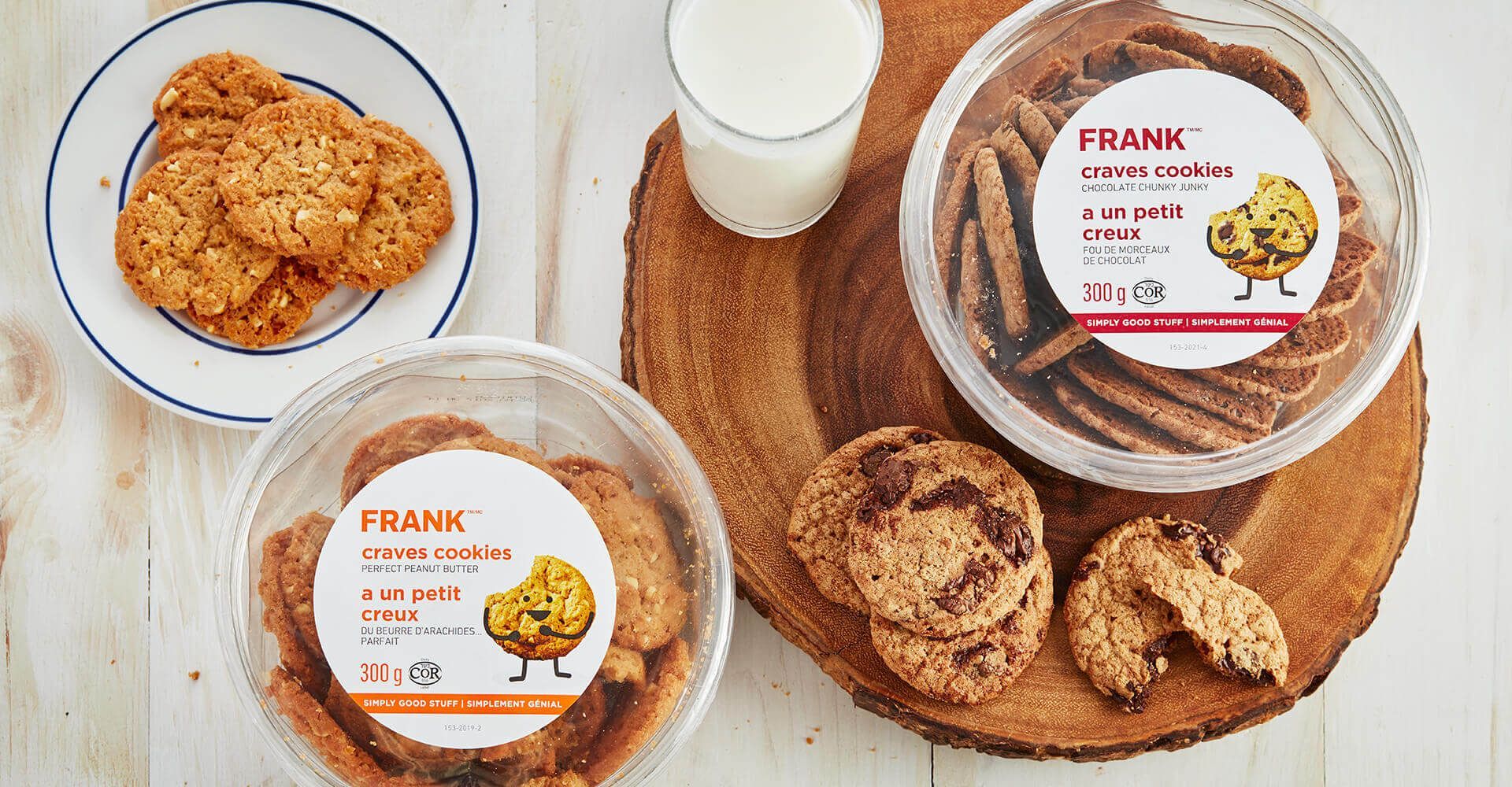 A tray of cookies and a glass of milk on a wooden table.